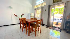 a dining room with a table and chairs and a refrigerator at 2 Bedroom Apartment 250 meters from the Beach in Poste Lafayette