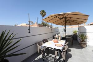 a patio with a table and an umbrella at Riad Modern Bed & Breakfast in Marrakech