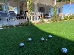 a group of balls sitting on a lawn at Peach on Beach Boutique Guesthouse in Bloubergstrand