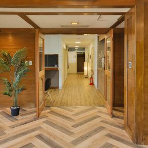 a hallway of an office building with a potted plant at Yufuin Monday 湯布院マンデー in Yufu
