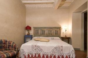 een slaapkamer met een bed met een witte sprei bij Casa Sofia in Fiesole
