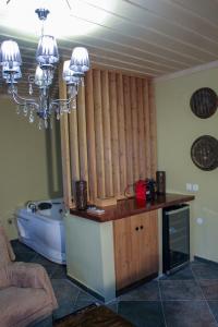 a kitchen with a bath tub and a chandelier at Oikies Art Rooms in Ángistron +56 photos