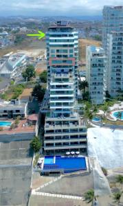 The Best Luxury Penthouse - Beach View في مانتا: مبنى طويل عليه سهم اخضر