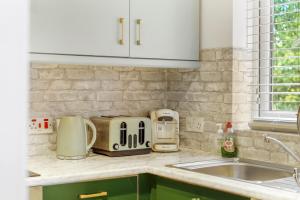 a kitchen counter with appliances on a counter top at Modern 1 Bed Apartments Near Middlesex Uni in Hendon in Colindale