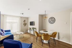 a living room with a couch and a table and chairs at Modern 1 Bed Apartments Near Middlesex Uni in Hendon in Colindale