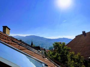 a view of the mountains from a roof at Potkrovlje u centru in Sarajevo