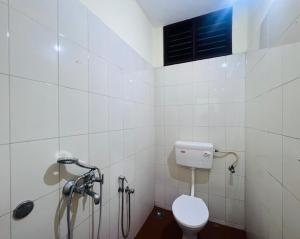 a bathroom with a toilet and a shower at Hotel Sunday - Townhouse Club Airport Trivandrum in Trivandrum