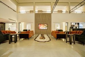 a living room with orange furniture and a fireplace at THE LOFT HOTEL By BRATUS in Aqaba