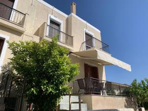 a building with balconies and a tree in front of it at La Bandolaise à Perdika in Perdika