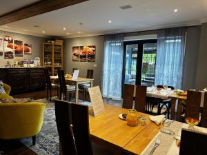 a dining room with a table and some chairs at Millers House Boutique B&B in Emsworth