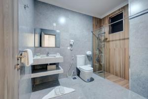 a bathroom with a toilet and a sink and a shower at THE LOFT HOTEL By BRATUS in Aqaba