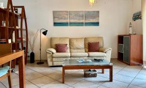 a living room with a couch and a coffee table at Atlantic Bay in Costa da Caparica