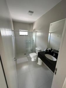 a bathroom with a shower and a toilet and a sink at Apartamento Frente Mar na Baía de Porto Belo in Porto Belo