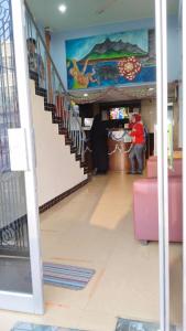 a hallway of a store with stairs and a mural at SUSAN HOTEL SEAFRONT in Sandakan