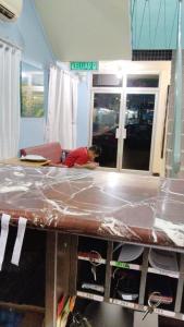 a person working on a counter in a room at SUSAN HOTEL SEAFRONT in Sandakan