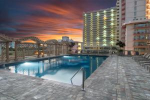 a swimming pool in front of a building at Island Colony 3715 in Honolulu