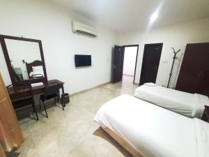 Ένα ή περισσότερα κρεβάτια σε δωμάτιο στο Al Reef Hotel Suits