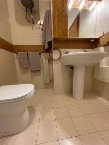 a bathroom with a toilet and a sink at Stanza Eur Tintoretto in Rome