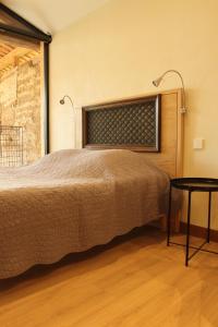 a bedroom with a bed and a table at La ferme de Berlioz in La Côte-Saint-André