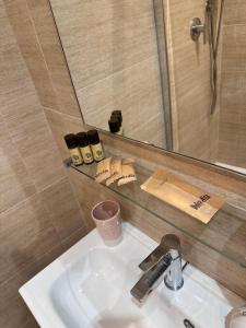 a bathroom sink with a mirror and a shower at Dolce vita al lago in Anguillara Sabazia