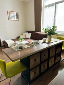 een woonkamer met een tafel en een bank bij Spacious city centre apartment in Bratislava