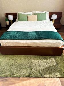 een bed met een groene deken en een groen tapijt bij Spacious city centre apartment in Bratislava