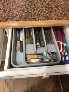 a drawer filled with utensils in a cabinet at Casa la Torre in Cambados