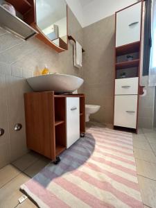 a bathroom with a sink and a mirror at San Martino-Flexrent Immobiliare Abissinia in Riccione