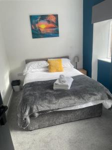 a bedroom with a bed with towels on it at One-Bedroom Apartment: Sleeps 4 Comfortably in Berwick-Upon-Tweed