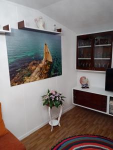 a living room with a painting on the wall at Casa la Torre in Cambados