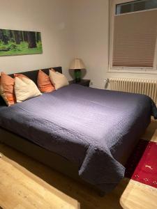 a large bed with a purple comforter in a bedroom at Schöne 2,5 Zimmer Wohnung in Dortmund-Hörde Phönix! in Dortmund