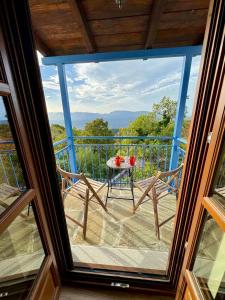 a view of a balcony with a table and chairs at Vradeto Guesthouse in Vradéton
