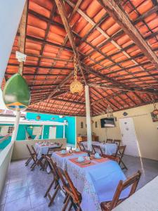 a dining room with a table and chairs in it at Pousada Verdes Mares Porto De Galinhas in Porto De Galinhas