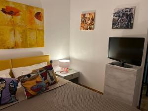 a bedroom with a bed and a flat screen tv at Casa Milano Expo SP in Milan