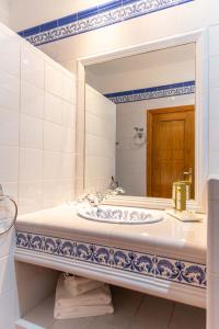 a bathroom with a sink and a mirror at Santuario Virgen de la Fuente in Peñarroya de Tastavins