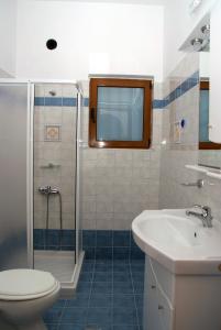 a bathroom with a toilet and a sink and a shower at Stis Kyra - Vasilikis in Ioannina
