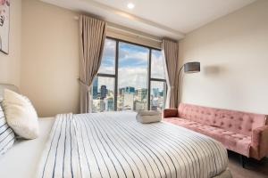 a bedroom with a large bed and a window at MIN' Apartment - Saigon Royal - Upscale Apartment - near Ben Thanh - Downtown in Ho Chi Minh City