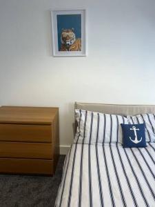 a bedroom with a bed with a tiger picture on the wall at Substantial 5 Bed Townhouse in Peterhead