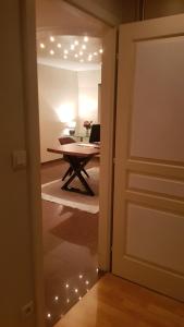 a door leading into a room with a table with a laptop at Green Field Lodge in Lingolsheim