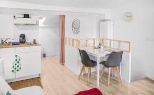 a kitchen and dining room with a table and chairs at L'oiseau Bleu in Aubagne