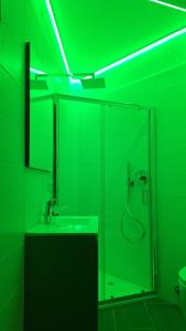 a green bathroom with a sink and a glass shower at Petit Bijou - Cervinia - BOX AUTO - CIR 0151 in Breuil-Cervinia
