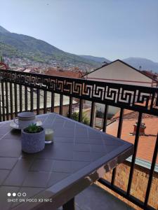 a table on a balcony with a view at Apartment Prizren New and Modern in Prizren