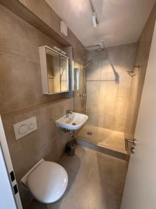a small bathroom with a toilet and a sink at ELBI Apartment in Frankfurt/Main