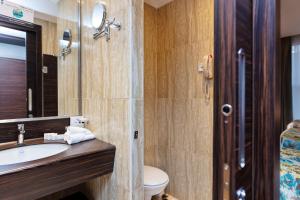 a bathroom with a sink and a toilet at M Hotel Makkah by Millennium in Mecca +20 photos