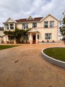 a house with a large driveway in front of it at A beautiful Large 7 bed house in Porthcawl