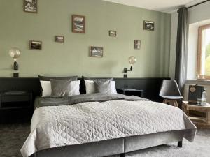 a bedroom with a large bed and a window at Wohlfühlherberge Weitblick in Erlbach