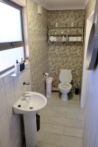 a bathroom with a toilet and a sink at Blue Sky Retreat in Vredenburg