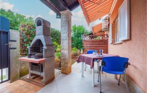 a patio with a table and a wood stove at 1 Bedroom Gorgeous Apartment In Banjole in Banjole
