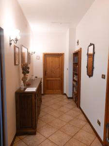 a hallway with a wooden door and a tiled floor at Pistoia ROSE Appartamento in Pistoia