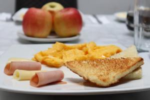 a plate of food with bread and cheese and apples at Hotel Tranvia in Santa Marta
